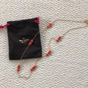 Kate Spade gold tone necklace with orange bows